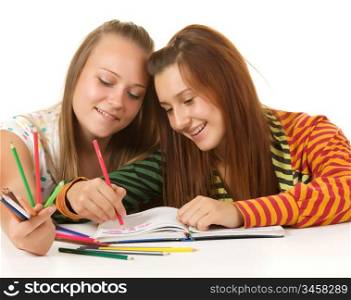 Two teenage girls smiling and reading book isolated on white