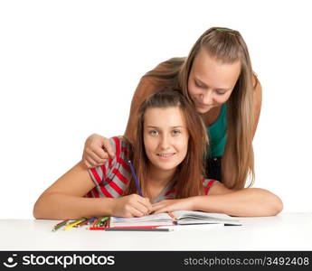 Two teenage girls smiling and reading book isolated on white