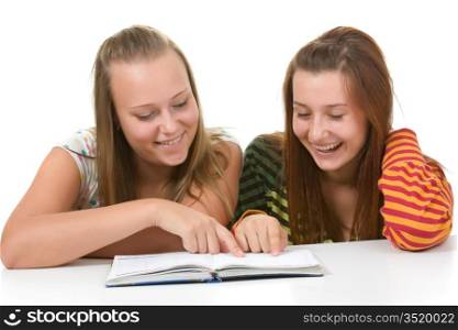 Two teenage girls smiling and reading book isolated on white