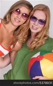 Two teenage girls wearing sunglasses