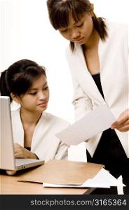 Two teenage girls working in an office