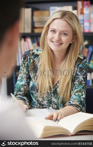 Two Teenage Students Working In Classroom Together