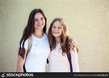 Two teenager smiling sisters girls
