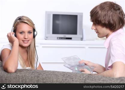 Two teenagers at home listening to music