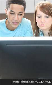 Two teenagers in front of computer