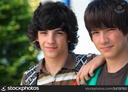 two teenagers posing