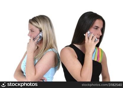 Two teens back to back speaking on cellphones.