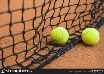 two tennis ball near black net ground. Resolution and high quality beautiful photo. two tennis ball near black net ground. High quality beautiful photo concept