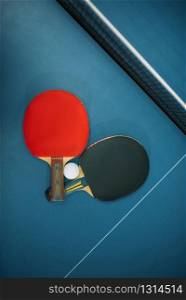 Two tennis rackets and ball on the table closeup, game concept. Ping pong sport equipment. Tennis rackets and ball on the table, game concept