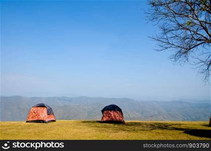 Two tents camping beside the cliff sky background with copy space