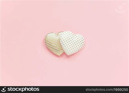 Two textile hearts with golden pattern on pink background, central composition, minimal style. Concept love, relationships. Template for Valentine card, wedding invitation and greeting card.. Two textile hearts with golden pattern on pink background, central composition, minimal style. Concept love, relationships. Template for Valentine card, wedding invitation and greeting card