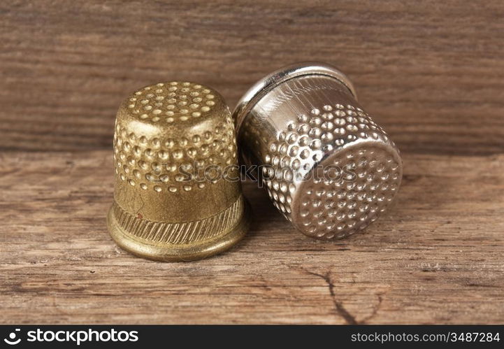 two thimble on a wooden background