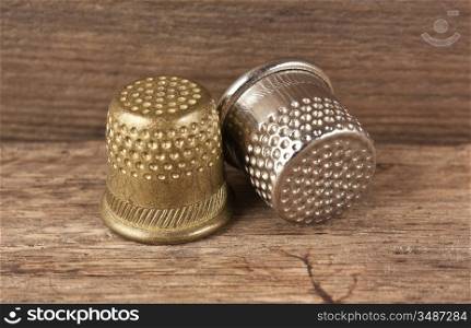 two thimble on a wooden background