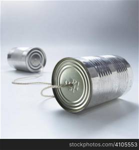 two tin cans joined with piece of string