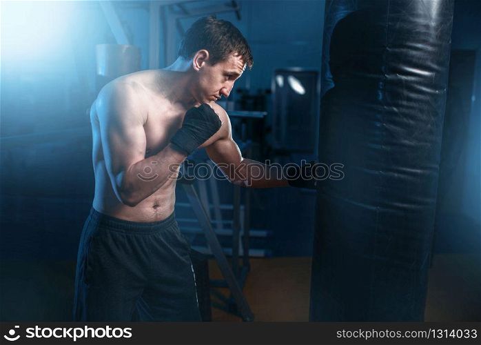 Two tired athletes doing exercise with dumbbells, training in gym. Fit workout in sport club, healthy lifestyle, fitness