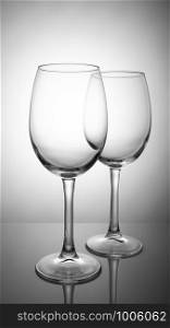 Two transparent wine glasses isolated on white background.. Two transparent wine glasses isolated on white background