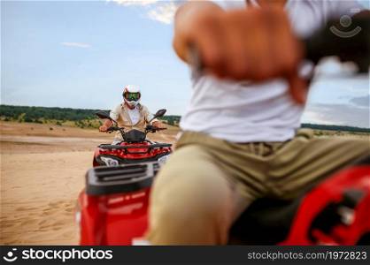 Two travelers, freedom atv riding in desert sands. Male persons on quad bikes, sandy race, dune safari in hot sunny day, 4x4 extreme adventure, quad-biking. Two travelers, atv riding in desert sands