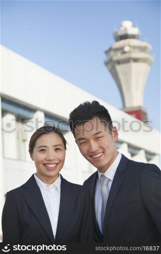 Two travelers portrait at airport