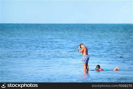 two unidentified children snorkeling on the beach in Spain. two unidentified children snorkeling on the beach