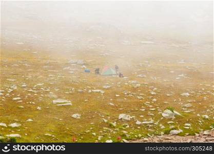 Two unidentified hikers with large backpacks camping on mountain Kackarlar. Kackar Mountains are a mountain range that rises above the Black Sea coast in eastern Turkey. hikers with large backpacks camping on mountain Kackarlar