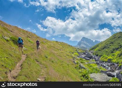 Two unidentified hikers with large backpacks hiking on mountain Kackarlar. Kackar Mountains are a mountain range that rises above the Black Sea coast in eastern Turkey. hikers with large backpacks hiking on mountain Kackarlar