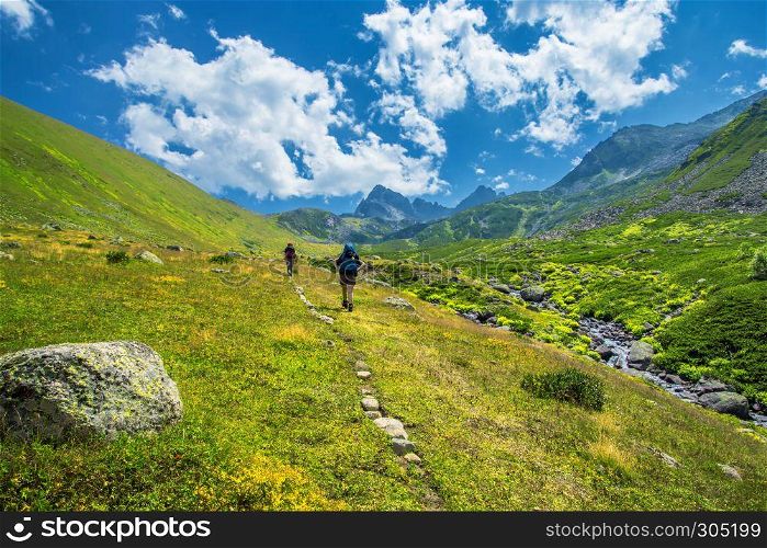 Two unidentified hikers with large backpacks hiking on mountain Kackarlar. Kackar Mountains are a mountain range that rises above the Black Sea coast in eastern Turkey. hikers with large backpacks hiking on mountain Kackarlar