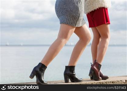 Two unrecognizable fashionable women wearing stylish shoes outdoor. Boots perfect for autumn and winter. Two women presenting shoes outdoor