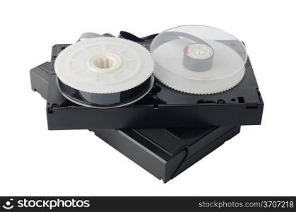 Two videotapes and reel on white reflective background.