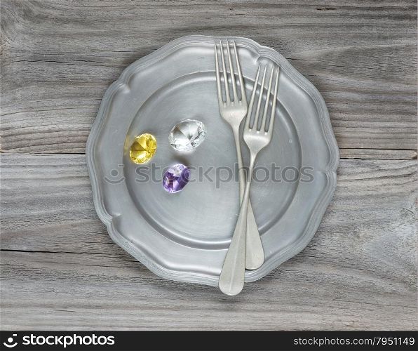 Two vintage fork and gems on an empty pink plate