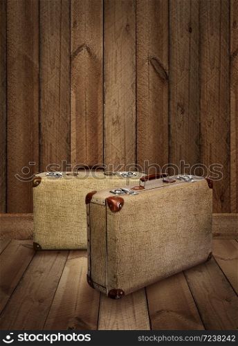 Two vintage suitcases on rough wooden plank background