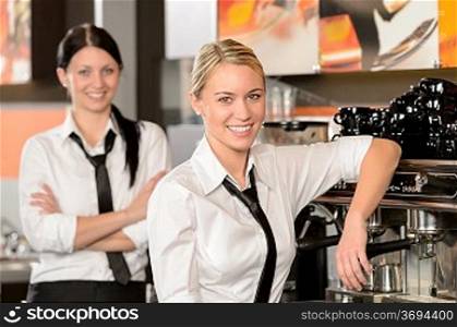 Two waitresses posing in coffee house in uniform