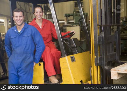 Two warehouse workers with forklift