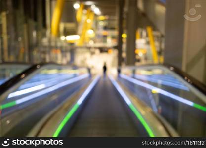 Two ways escalator in shopping mall abstract blurred background