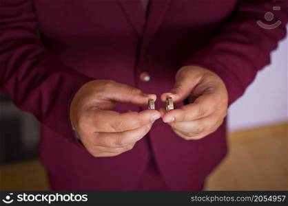 Two wedding rings in the hands of a young guy.. A man holds wedding rings in his hands 2795.