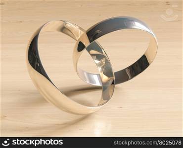 Two wedding rings on wooden background