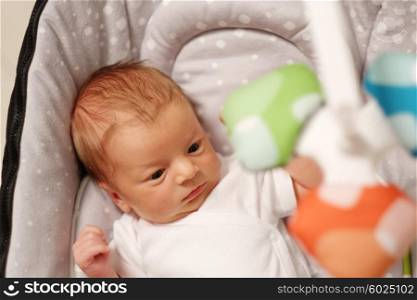 Two weeks old newborn baby in infant seat