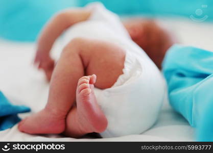 Two weeks old newborn baby&rsquo;s legs and bottom in diaper