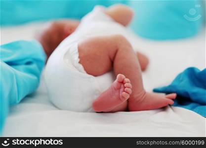 Two weeks old newborn baby&rsquo;s legs and bottom in diaper