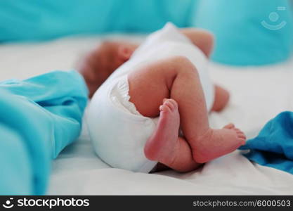 Two weeks old newborn baby&rsquo;s legs and bottom in diaper