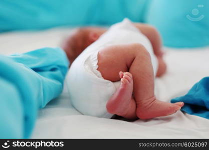 Two weeks old newborn baby&rsquo;s legs and bottom in diaper