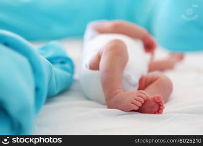 Two weeks old newborn baby&rsquo;s legs and bottom in diaper