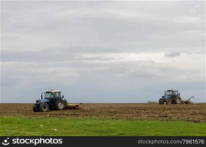 Two wheeled tractors sow a field of wheat, Ludogorie, Bulgaria