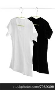Two, white and black t-shirt on a hanger. Isolate on white.