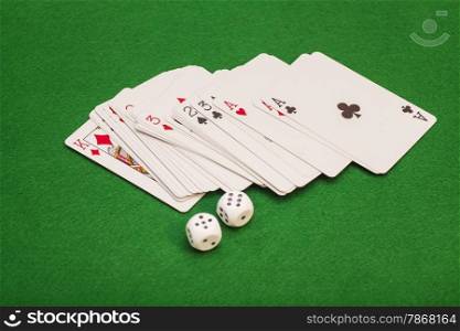 Two White Dices And Playing Cards On Green Cloth