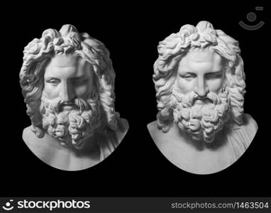 Two white gypsum copy of antique statue of Zeus head for artists isolated on a black background. Plaster sculpture of man face with beard. Zeus the ancient Greek god.. Two gypsum copy of antique statue Zeus head isolated on black background. Plaster sculpture man face with beard.