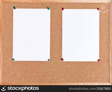 two white sheets of paper on cork board in wooden frame
