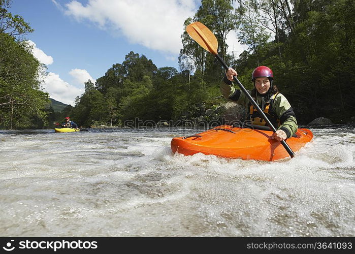 Two Whitewater Kayakers on River