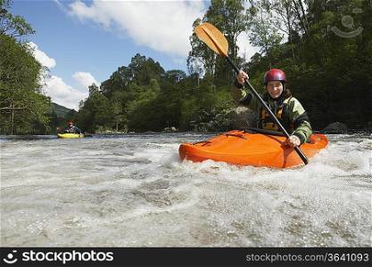 Two Whitewater Kayakers on River