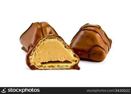 Two whole and one half of the chocolate candies with a pattern isolated on a white background