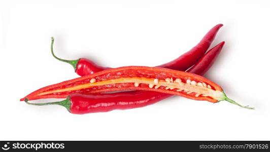 Two whole and one half red chili peppers isolated on white background